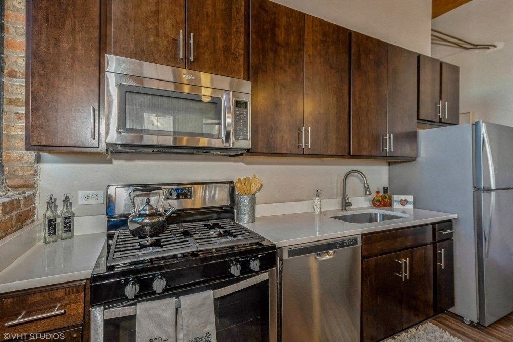 Stainless steel appliances with a built in microwave at Carriage House Lofts, Chicago, IL, 60605