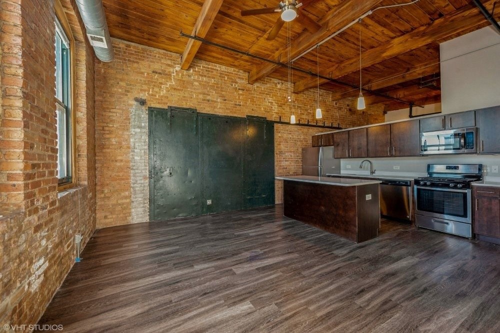 Spacious living area with a huge kitchen island at Carriage House Lofts, Illinois