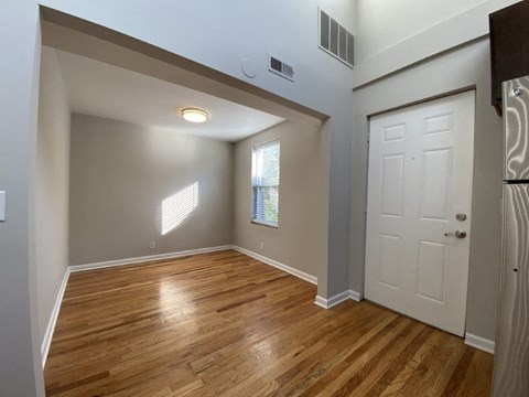 A room with wooden floors and a white door.