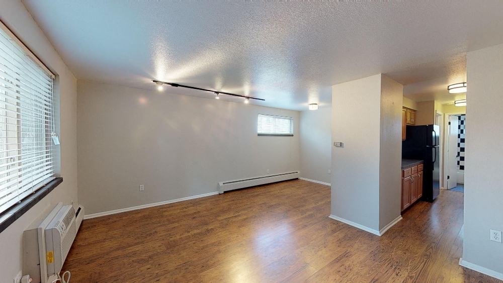 Spacious living area with hardwood floors