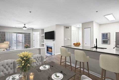 A modern kitchen with a dining table set for two.
