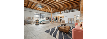 A room with a wooden ceiling and a rug on the floor.