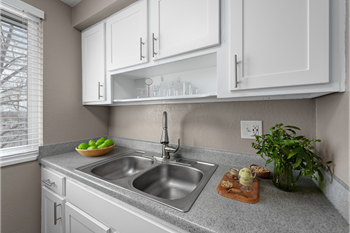 a kitchen with white cabinets and a sink