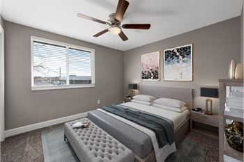 a bedroom with a large bed and a ceiling fan