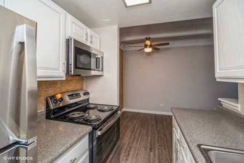 White cabinets and wood-like plank flooring at The Helix in Denver, CO