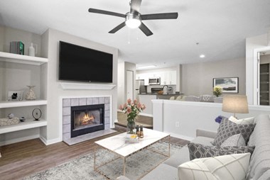 Renovated Sunken living room with a fireplace and a ceiling fan