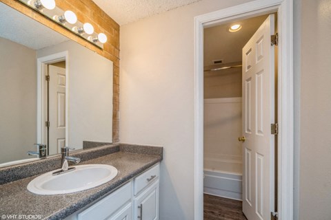 Bathroom with vanity storage and a full tub at The Helix in Denver, CO