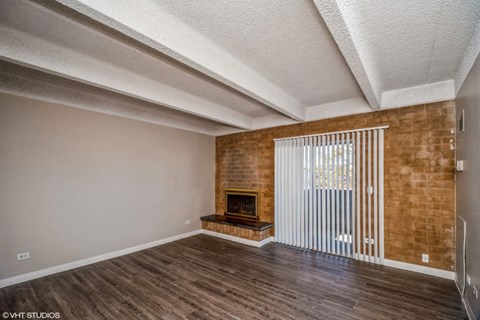 Living room with a fireplace and balcony access at The Helix in Denver, CO