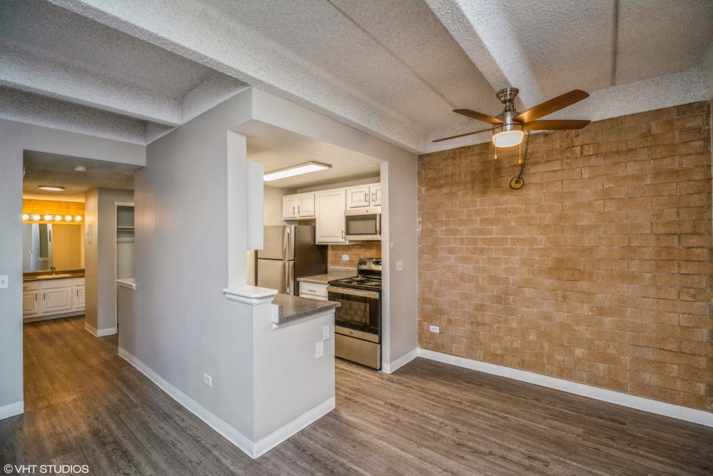 Open living area with a ceiling fan