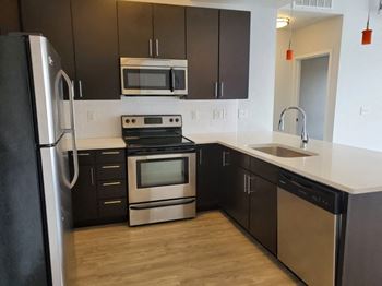 Built-in microwave and a glass top stove at Wash Park Station in Denver, CO