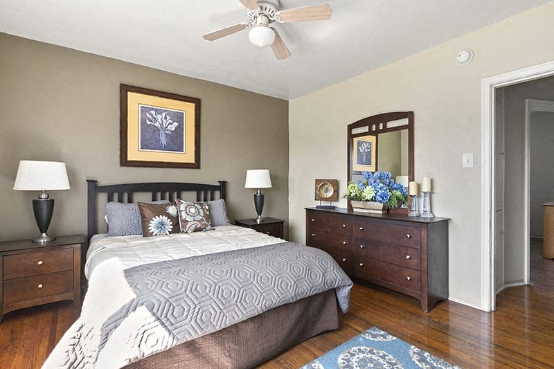 a bedroom with a bed and a ceiling fan