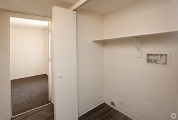 A room with a white wall and a picture frame on it.