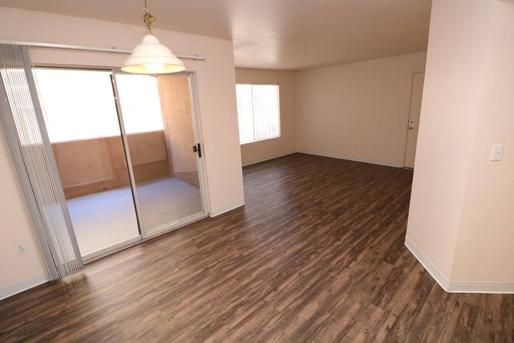 Spacious living area with access to large private patio at Canon de Arrowhead in Albuquerque, New Mexico