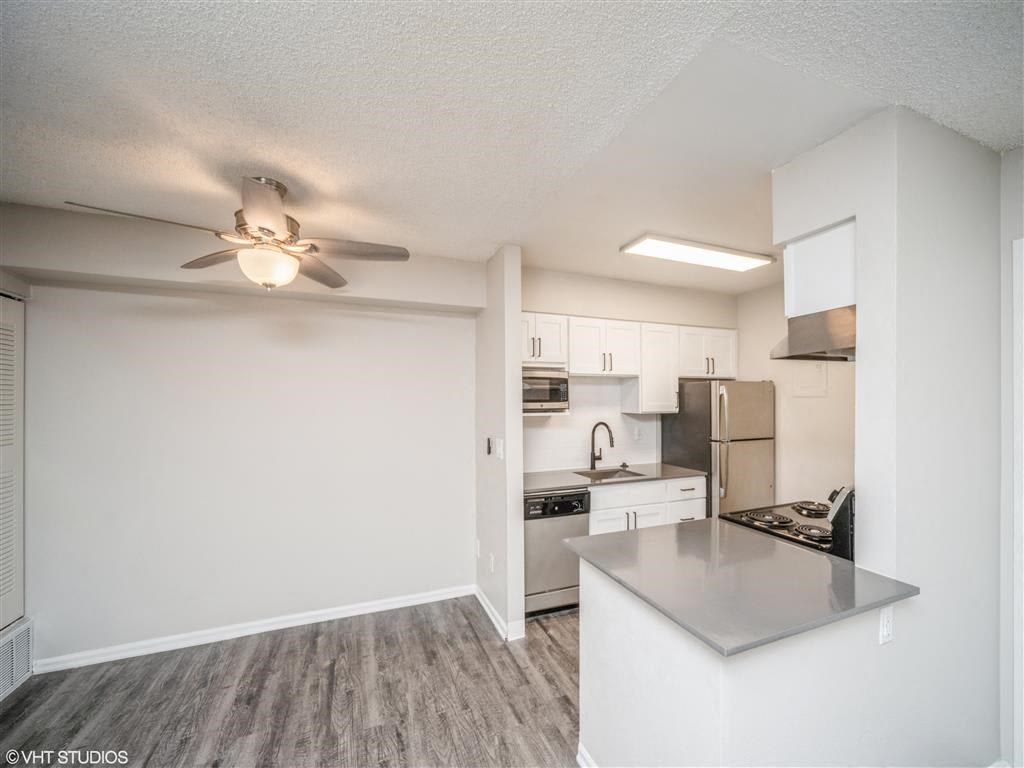 Open kitchen and living room with a ceiling fan  at Avery Park in Englewood, CO