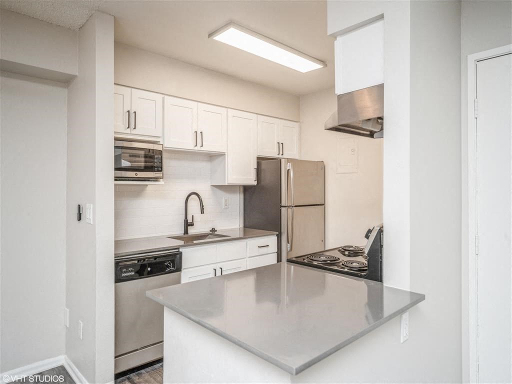 Kitchen with white cabinets and stainless steel counter tops  at Avery Park in Englewood, CO