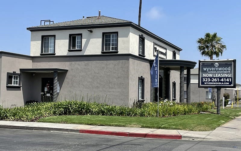 a white building with a sign in front of it