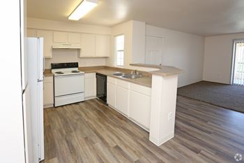 A kitchen with white appliances and cabinets.