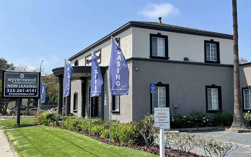 a building with blue and white flags in front of it