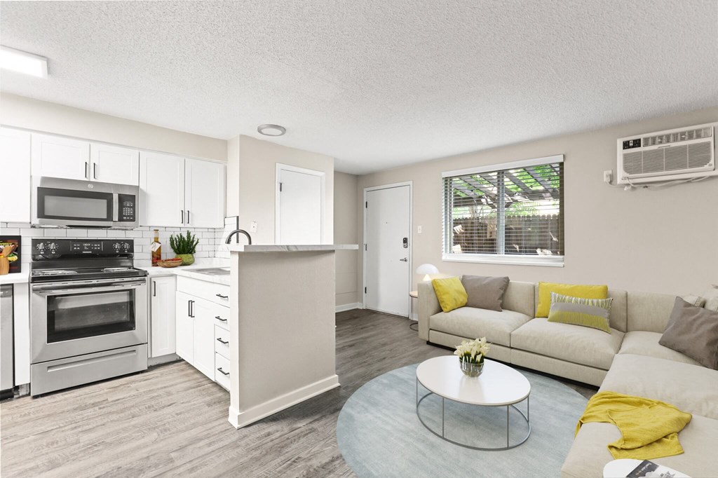 an open living room and kitchen with a couch and a table