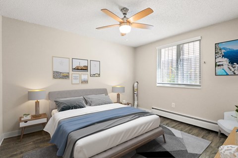 Bright bedroom with large window, ceiling fan, queen bed, and modern decor on light walls at 1443 Elizabeth in Denver, CO