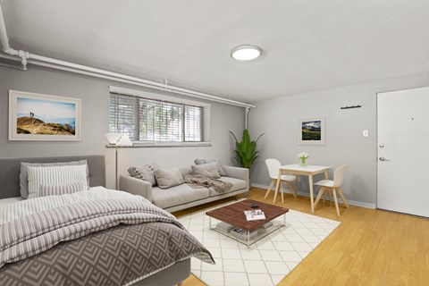 A bedroom with a bed, couch, and a small table at 1355 Pearl in Denver, CO
