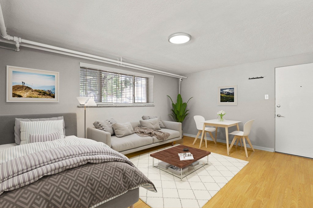 A bedroom with a bed, couch, and a small table at 1355 Pearl in Denver, CO