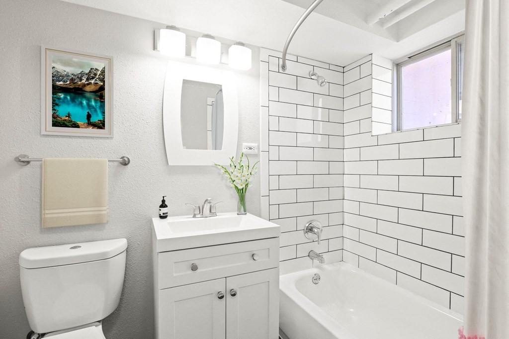 Bright, refreshed, and move-in ready. This spa-inspired bathroom features sleek subway tile, modern lighting, and a deep soaking tub at 1355 Pearl in Denver, CO
