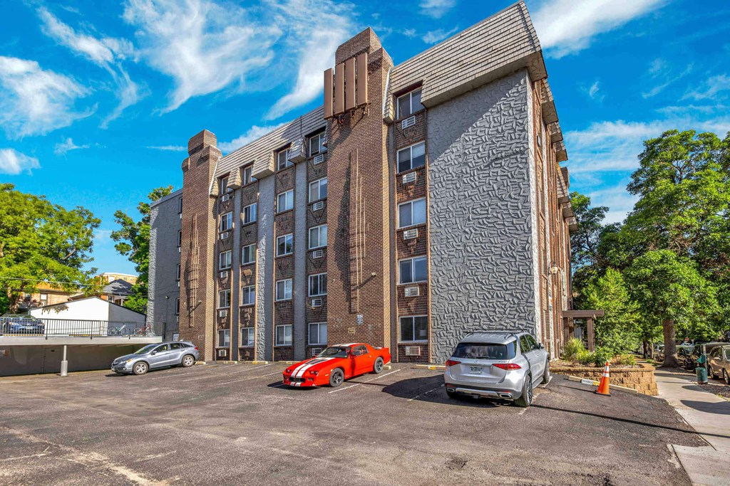 a large brick building with cars parked in front of it