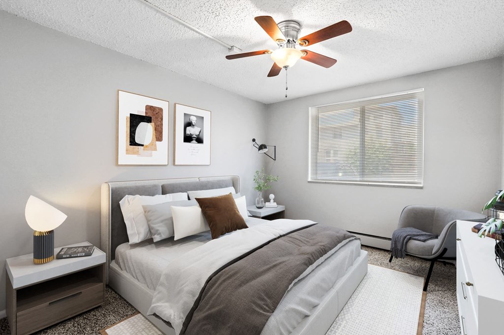 a bedroom with a bed and a ceiling fan