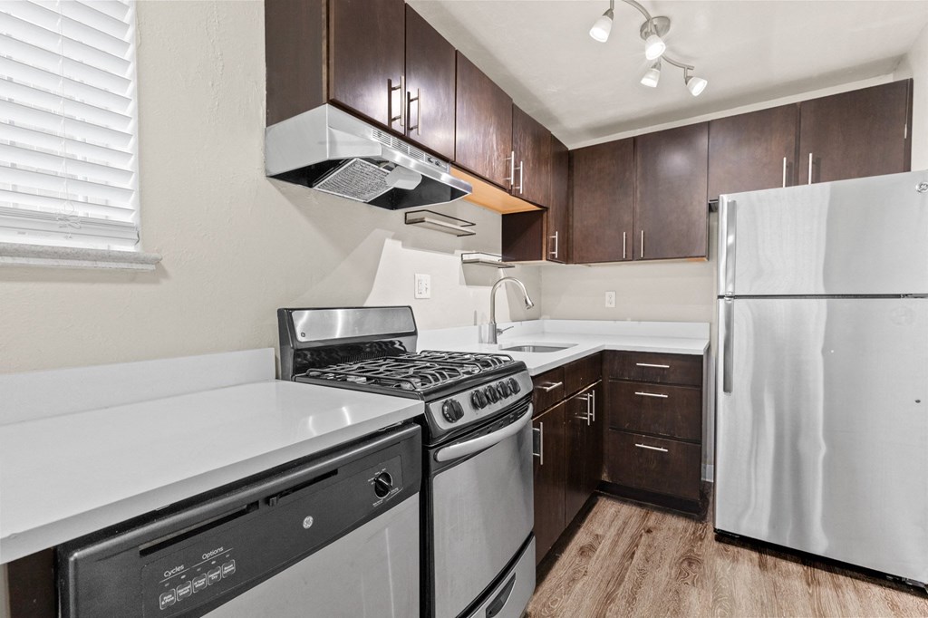 a kitchen with stainless steel appliances and wooden cabinets