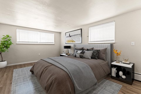 A bedroom with a large bed and a potted plant at 1444 Saint Paul St in Denver, CO