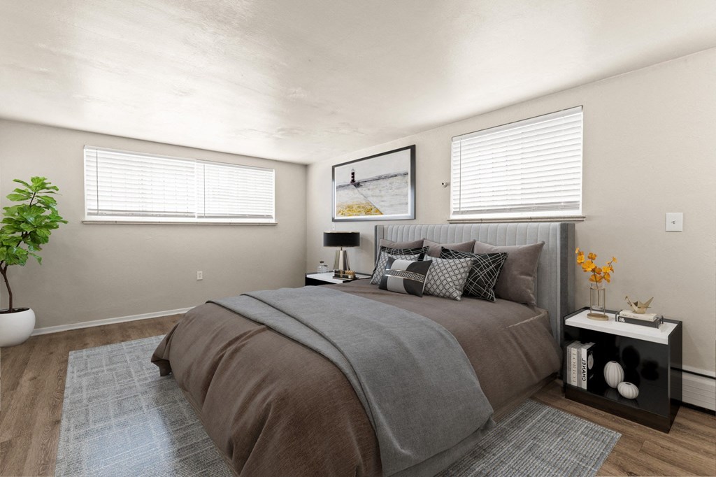 a bedroom with a bed and two windows