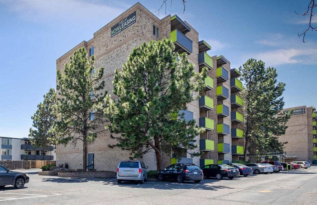 a large brick building with cars parked in front of it