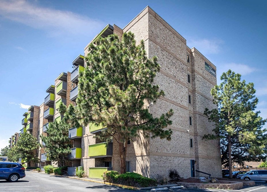 a building with a tree in front of it on a street