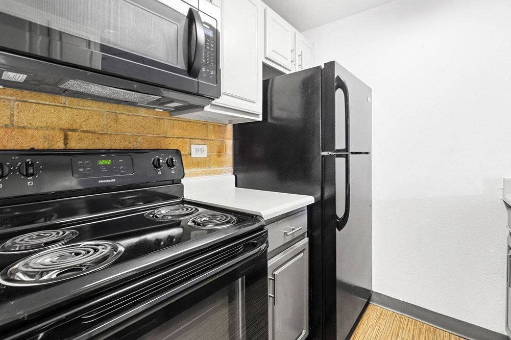 a kitchen with a stove and a refrigerator