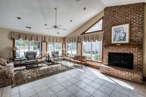 A living room with a fireplace and a painting on the wall.