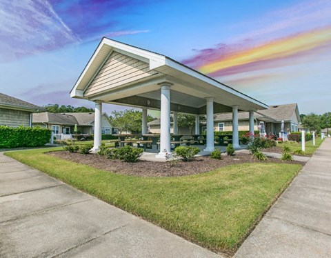 Large covered BBQ grilling area with picnic tables