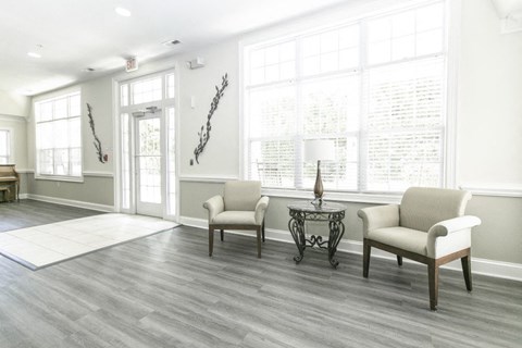 A living room with two chairs and a table.