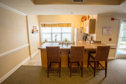 A kitchen with a table and chairs.
