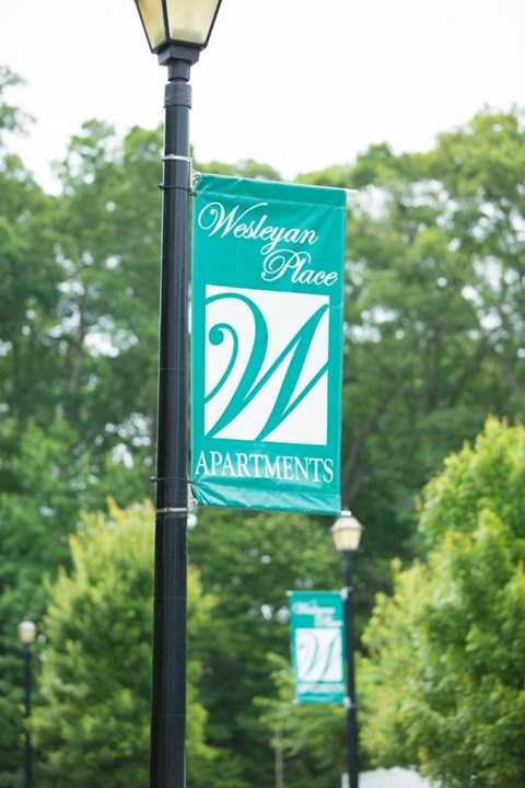 A sign for Westyan Place Apartments is displayed on a pole.