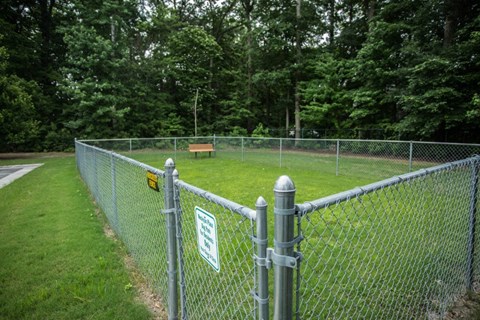 A chain link fence with a sign attached to it.