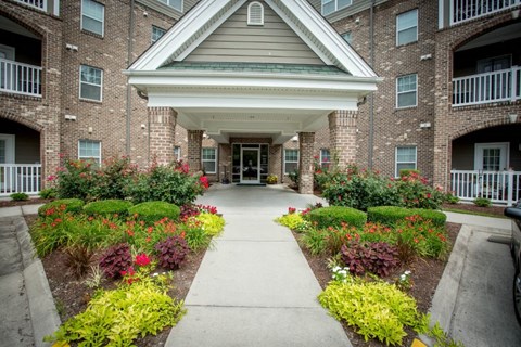 A building with a white roof and a walkway in front of it.
