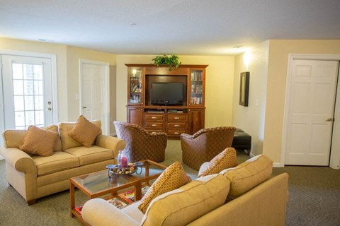 A living room with a couch, chair, and coffee table.