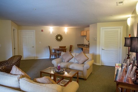 A living room with a couch, chair, and coffee table.