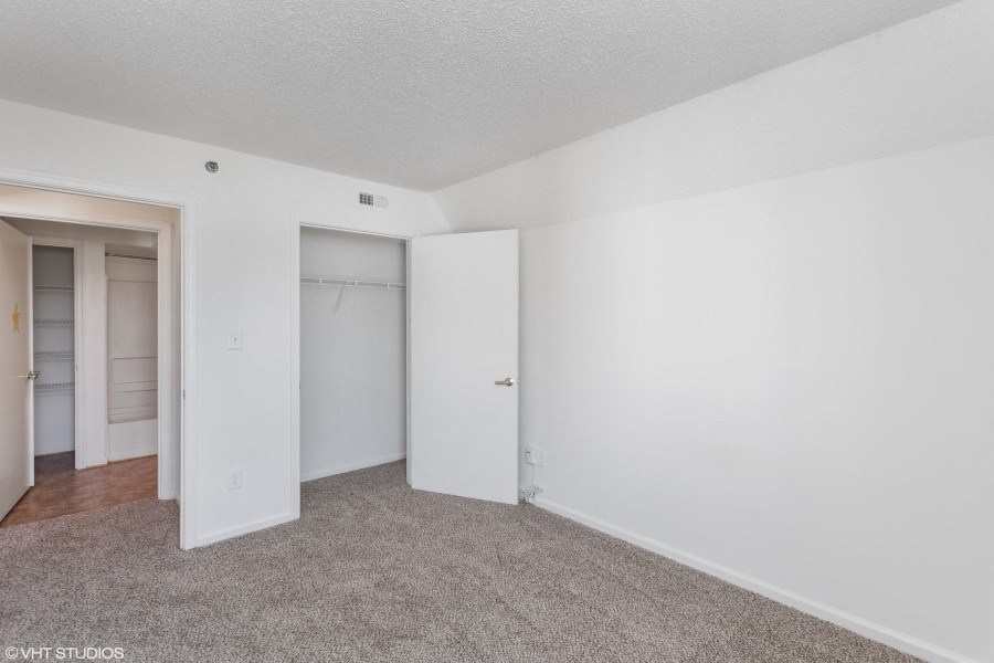 A room with white walls and carpeted floor.