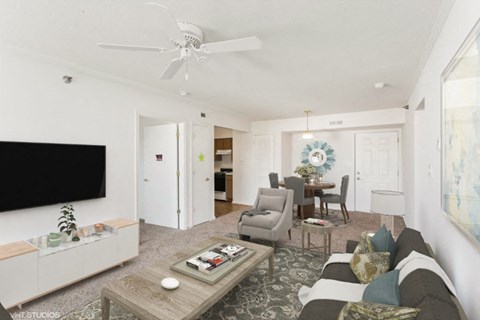 A living room with a grey couch and a coffee table.
