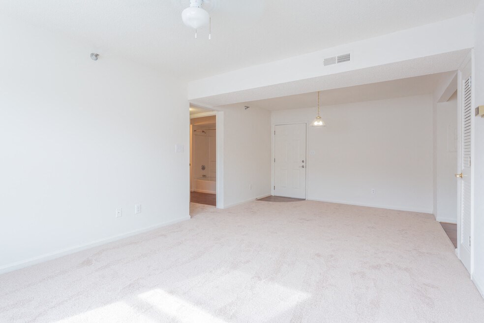 A white room with a doorway leading to another room.