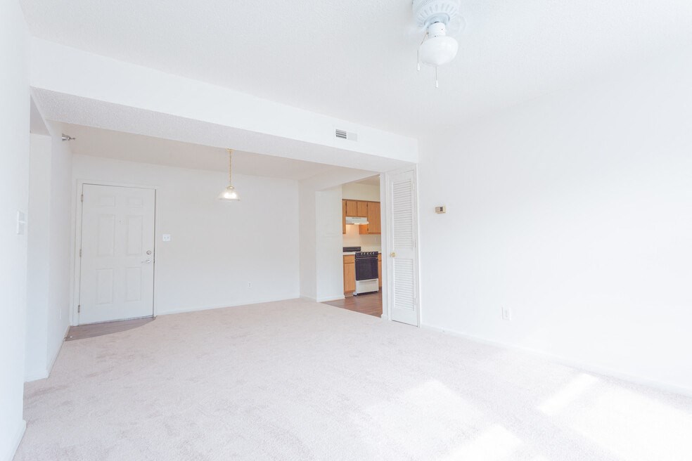 A white room with a doorway leading to another room.