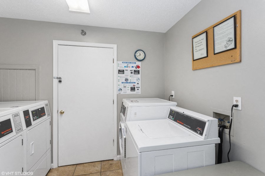 A room with a washing machine and dryer.
