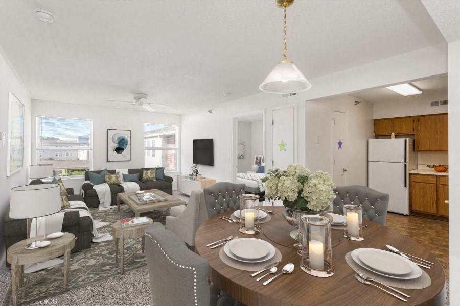 A dining room with a table set for dinner.